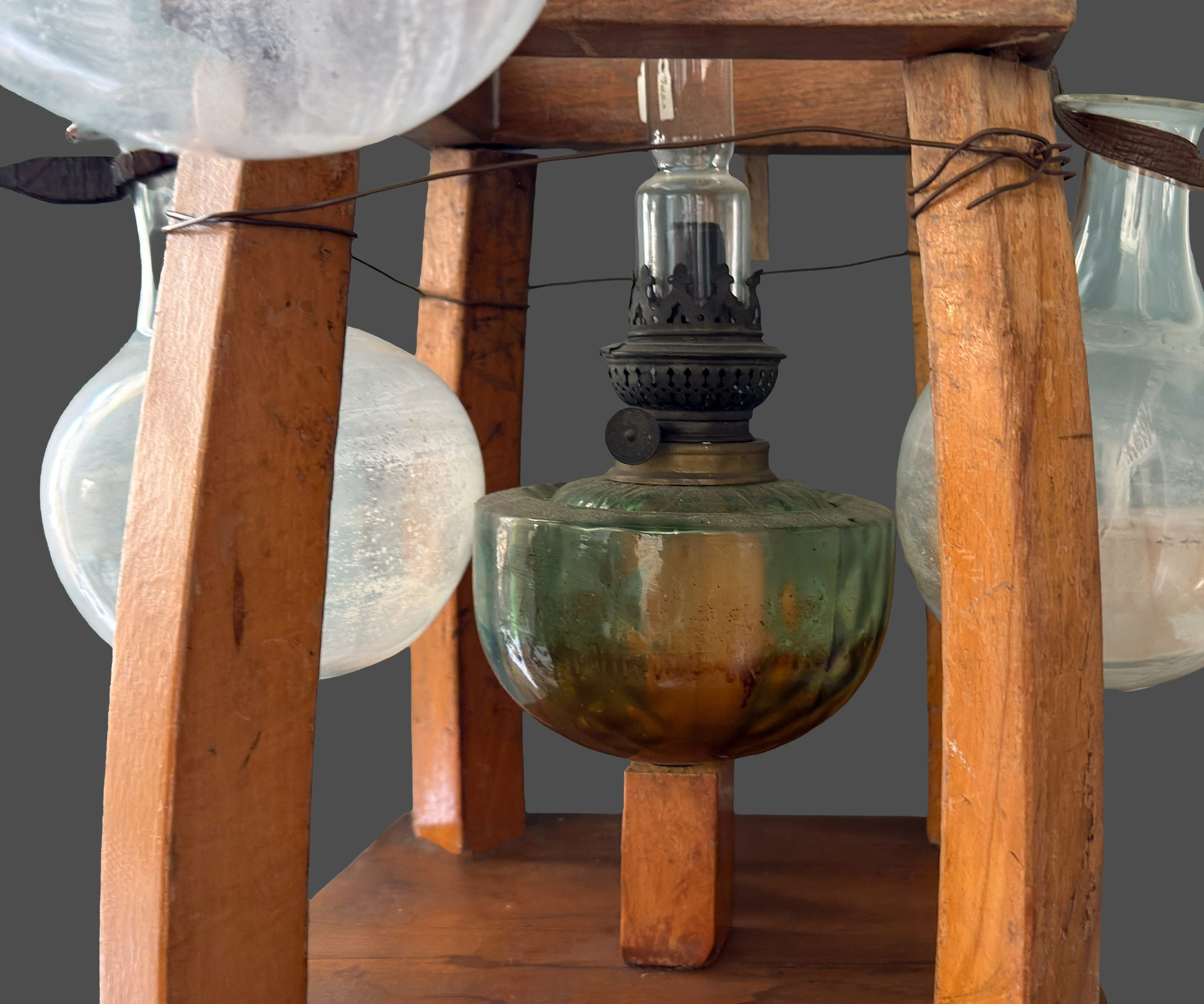 Close-up of the central oil lamp in the wooden stand